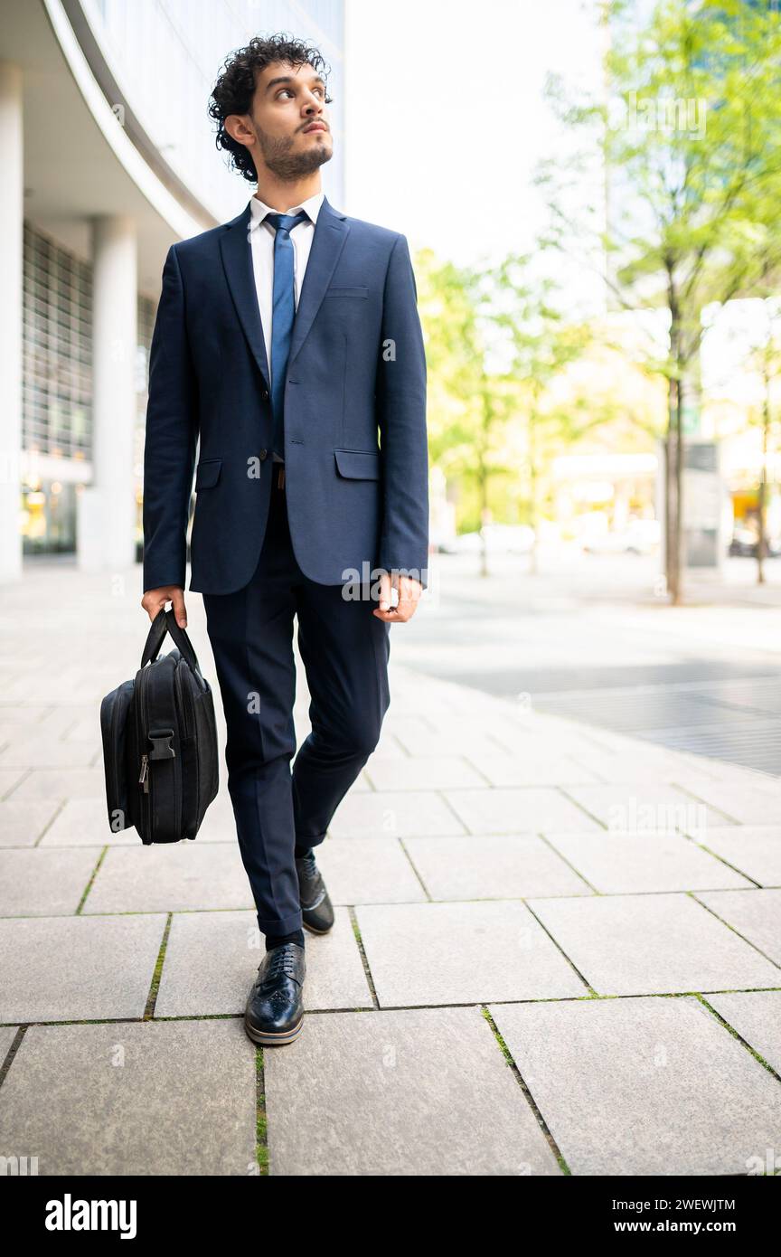Businessman walking with his bag Stock Photo