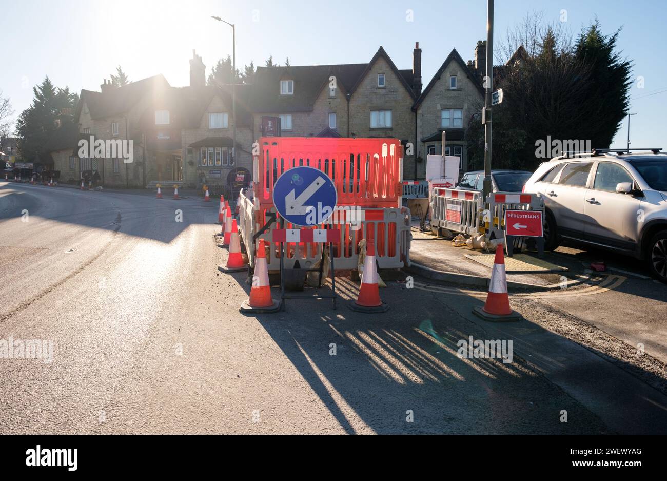 Road works with barriers and traffic cones in the middle of Redstone hill Redhill Surrey England. Stock Photo