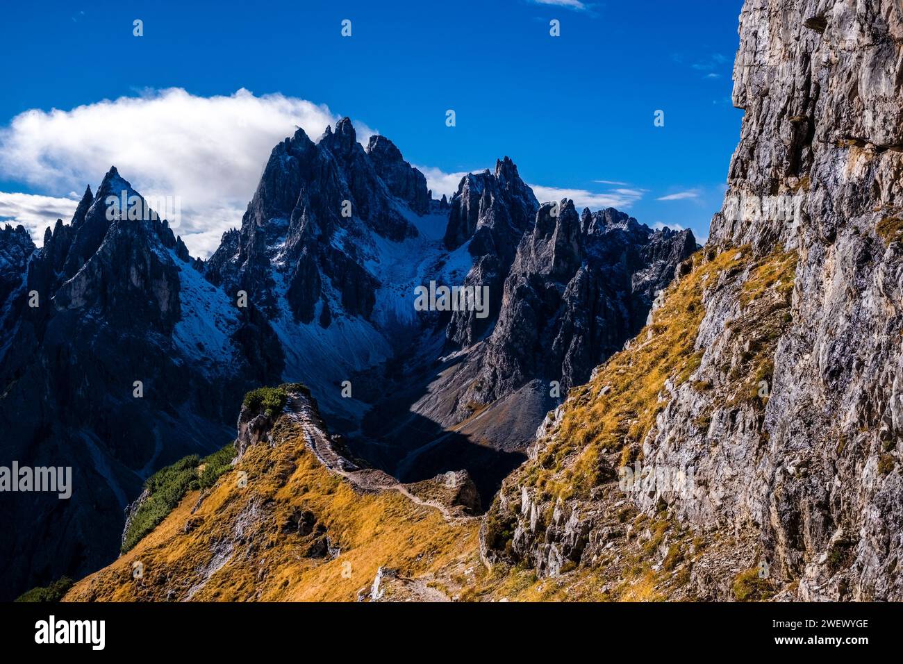 The rocky summits of the rock formation Cadini di Misurina in Tre Cime National Park, partially covered in fresh snow in autumn. Stock Photo