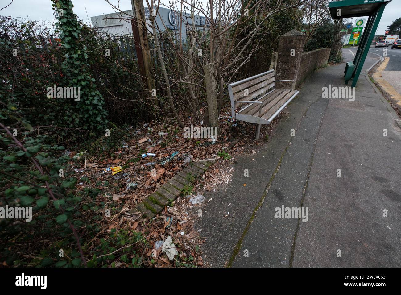 Huge amounts of litter build up next to bus stop in Bournemouth Dorset England discarded by irresponsible people waiting for buses. Stock Photo