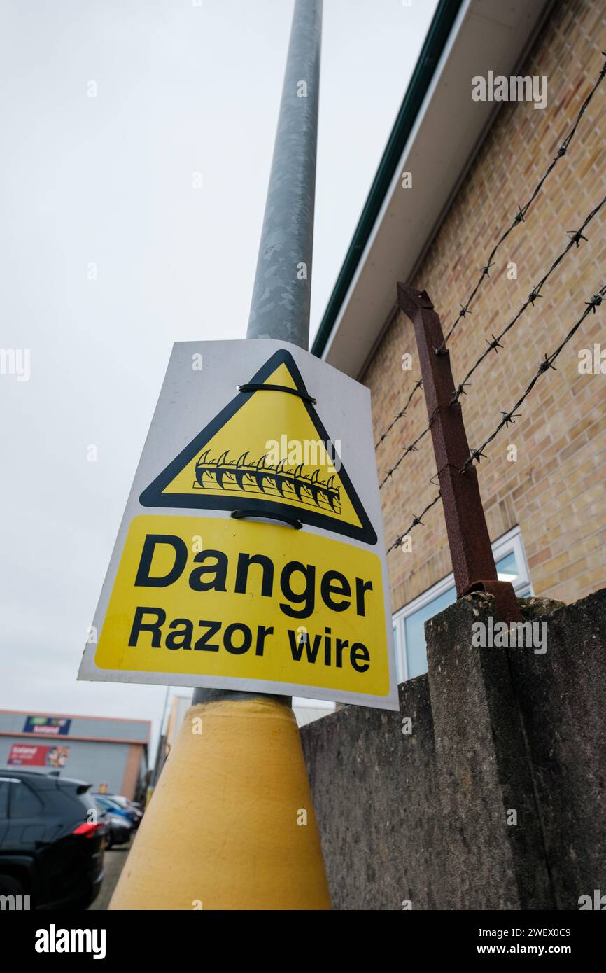 A warning sign to show Danger of Razor wire at a location to protect property in Bournemouth Dorset England. Stock Photo