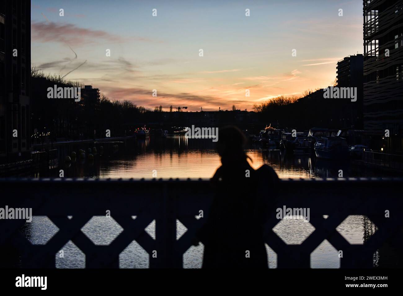 Paris France 27th Jan 2024 A Pedestrian Crosses The Canal De L   Paris France 27th Jan 2024 A Pedestrian Crosses The Canal De Lourcq During Sunset In Paris On January 26 2024 Photo By Firas Abdullahabacapresscom Credit Abaca Pressalamy Live News 2WEX3MH 