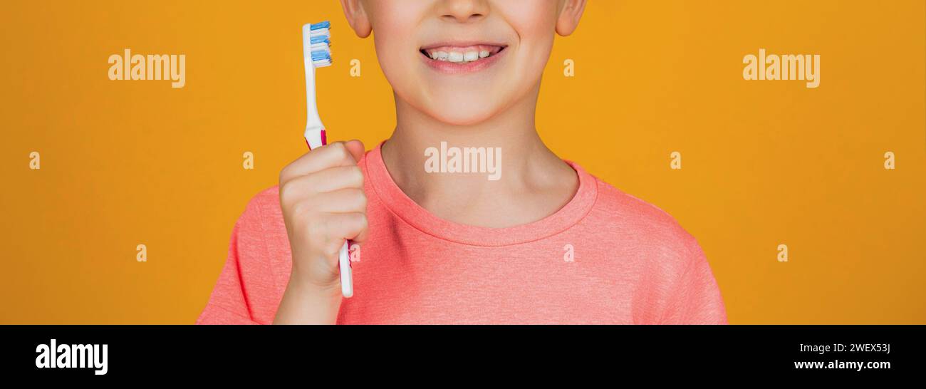 Boy toothbrush white toothpaste. Health care, dental hygiene. Joyful child shows toothbrushes. Little boy cleaning teeth. Dental hygiene. Happy little Stock Photo