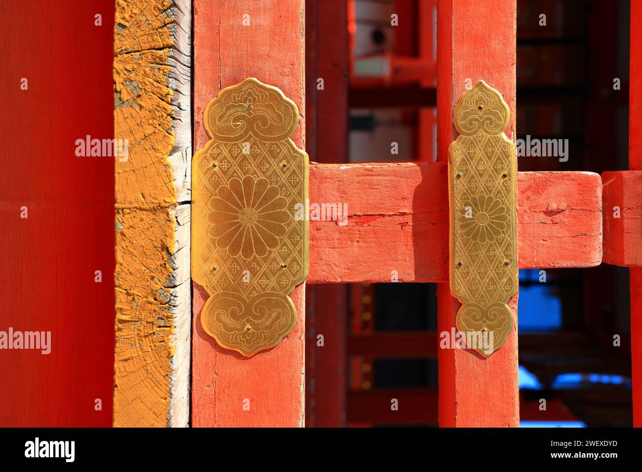 Antique decorative golden stake on red wooden gate of ancient japan temple. Stock Photo
