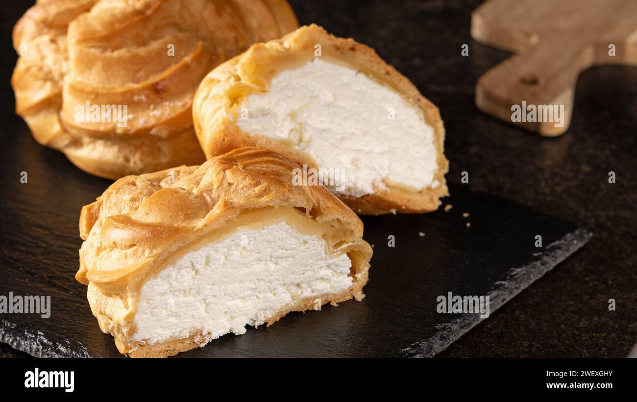 A delightful image showcasing authentic latvian delicacies - traditional Old Riga cottage cheese buns paired with a warm cup of tea, symbolizing the r Stock Photo