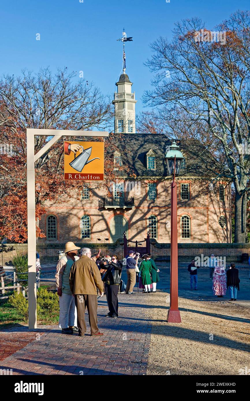 street scene, R. Charlton coffeehouse sign, lamppost, people, some in colonial garb, Capitol, brick sidewalk, trees, autumn, Colonial Williamsburg; Vi Stock Photo
