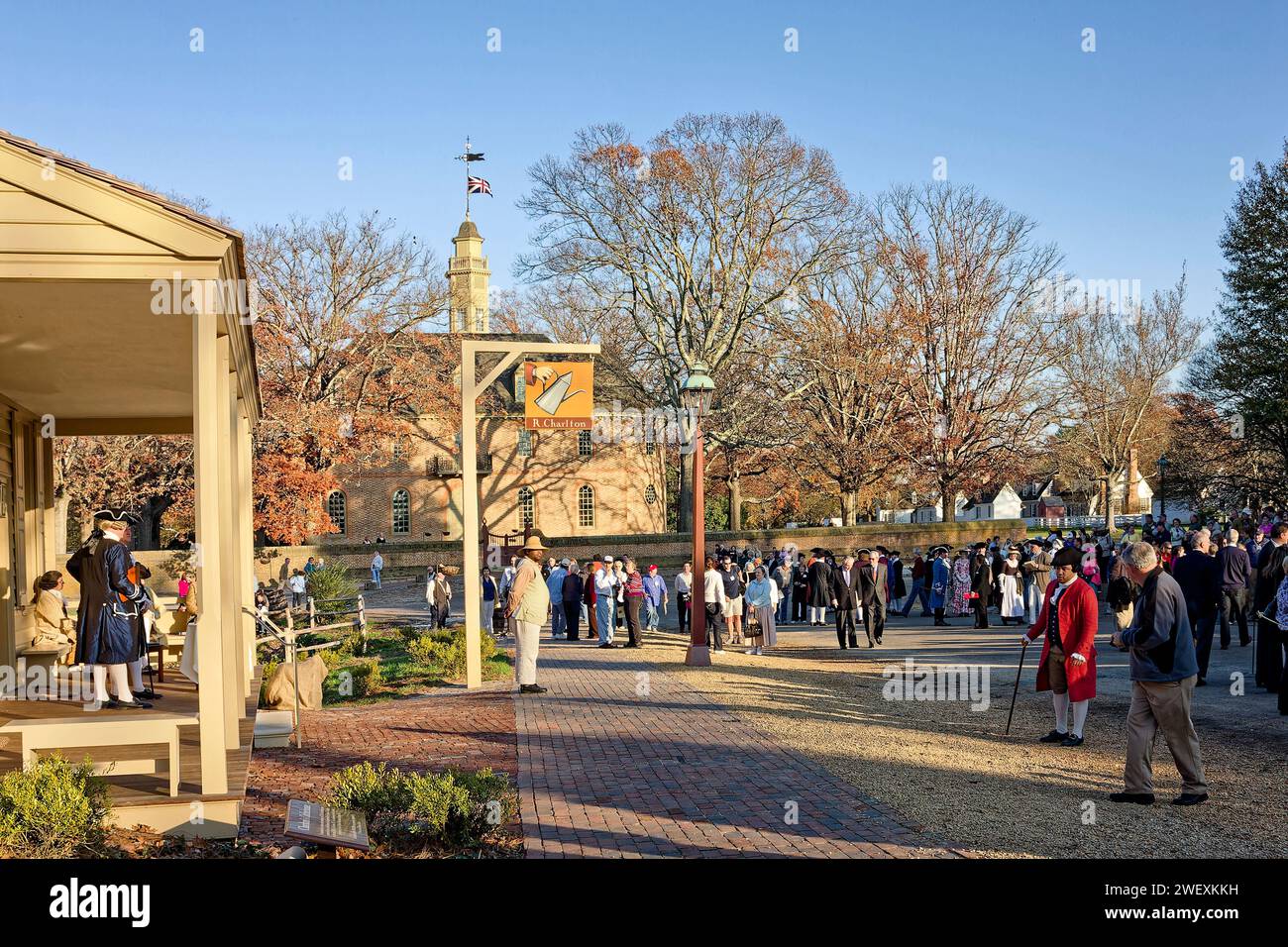 street scene, R. Charlton coffeehouse sign, lamppost, people, some in colonial garb, Capitol, brick sidewalk, trees, golden light, autumn, Colonial Wi Stock Photo