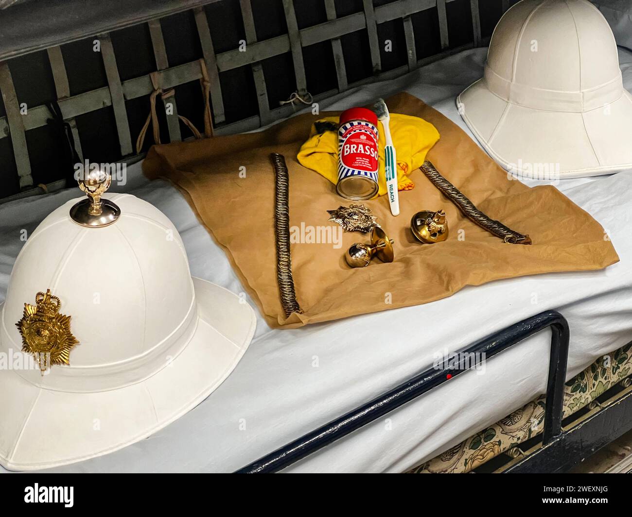 A British Safari Pith Helmet With Brass Detailing Rests On A Bunk In The Crews Quarters Onboard Her Majesty's Yacht Britannia Stock Photo