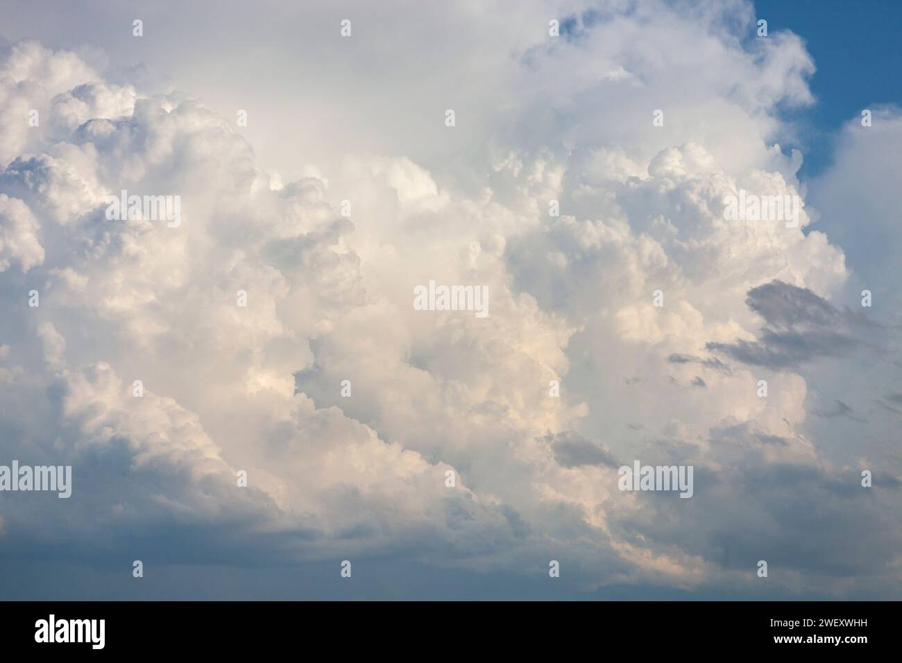 A dramatic cloudscape and blue sky on a summer evening Stock Photo