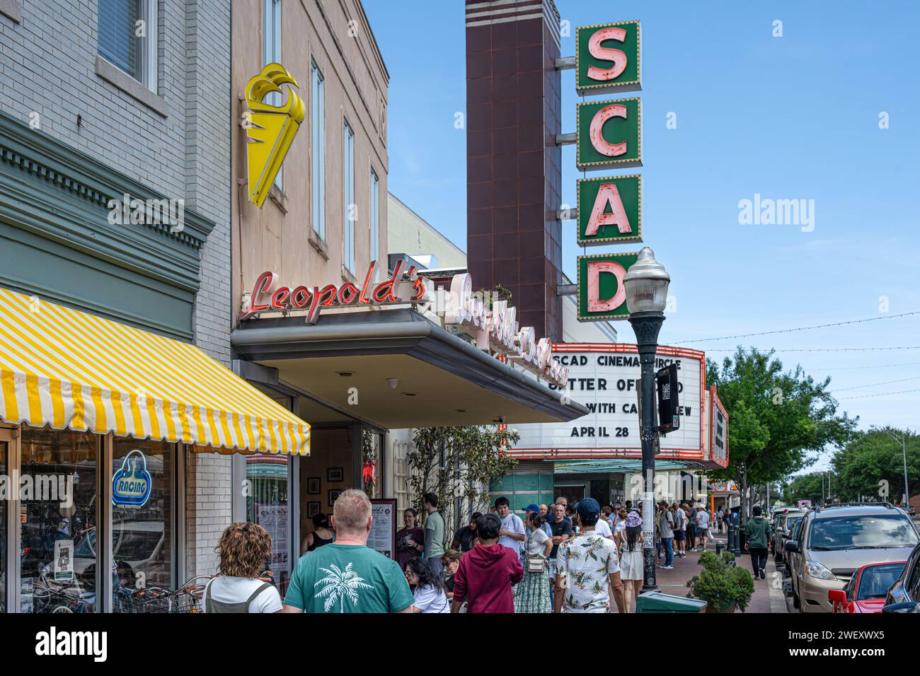 A long line for Leopold's Ice Cream forms beneath the SCAD (Savannah College of Art & Design) Trustee's Theater marquee in Downtown Savannah, Georgia. Stock Photo