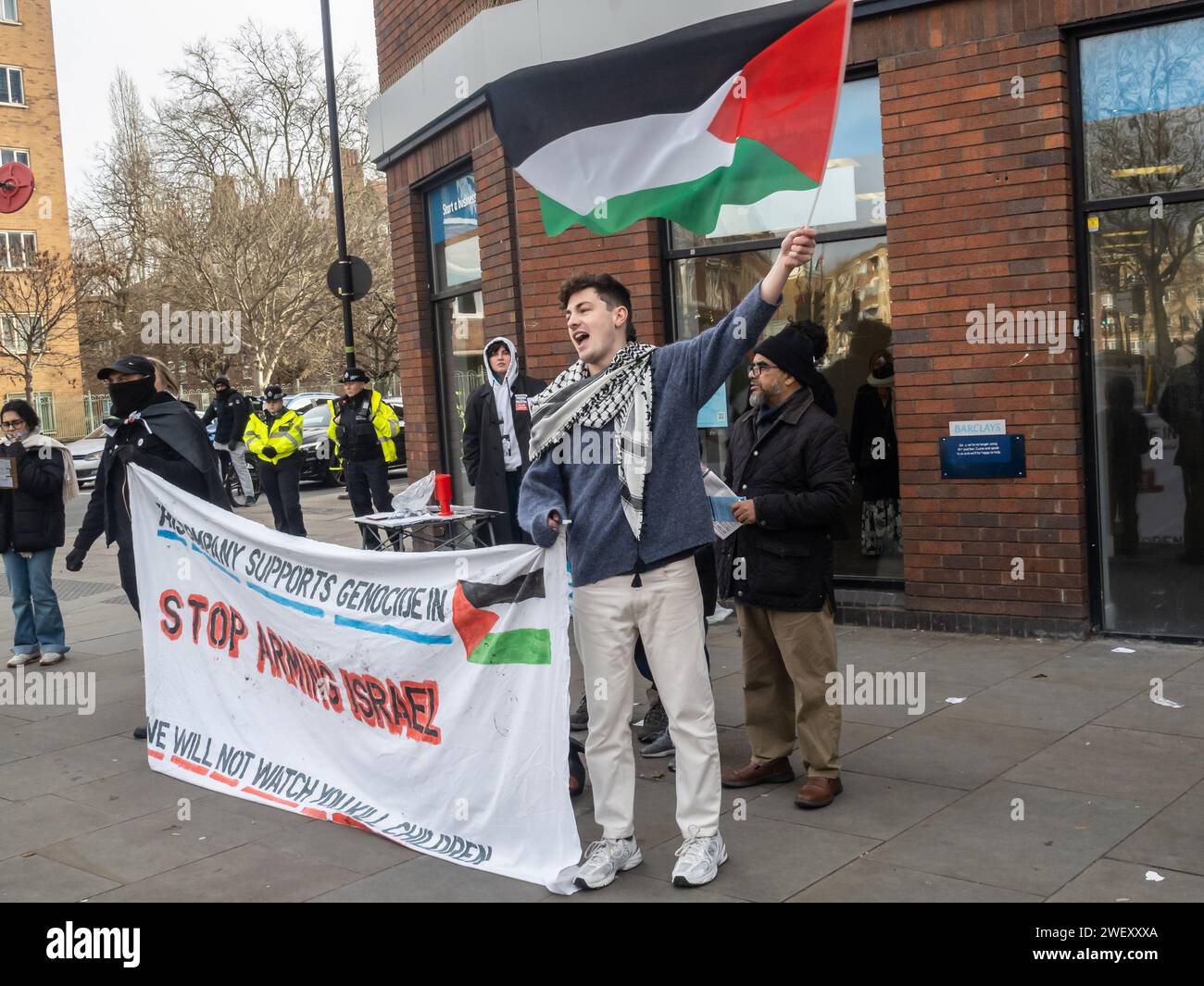London, UK. 27 Jan 2024. People protest outside Barclay's Whitechapel