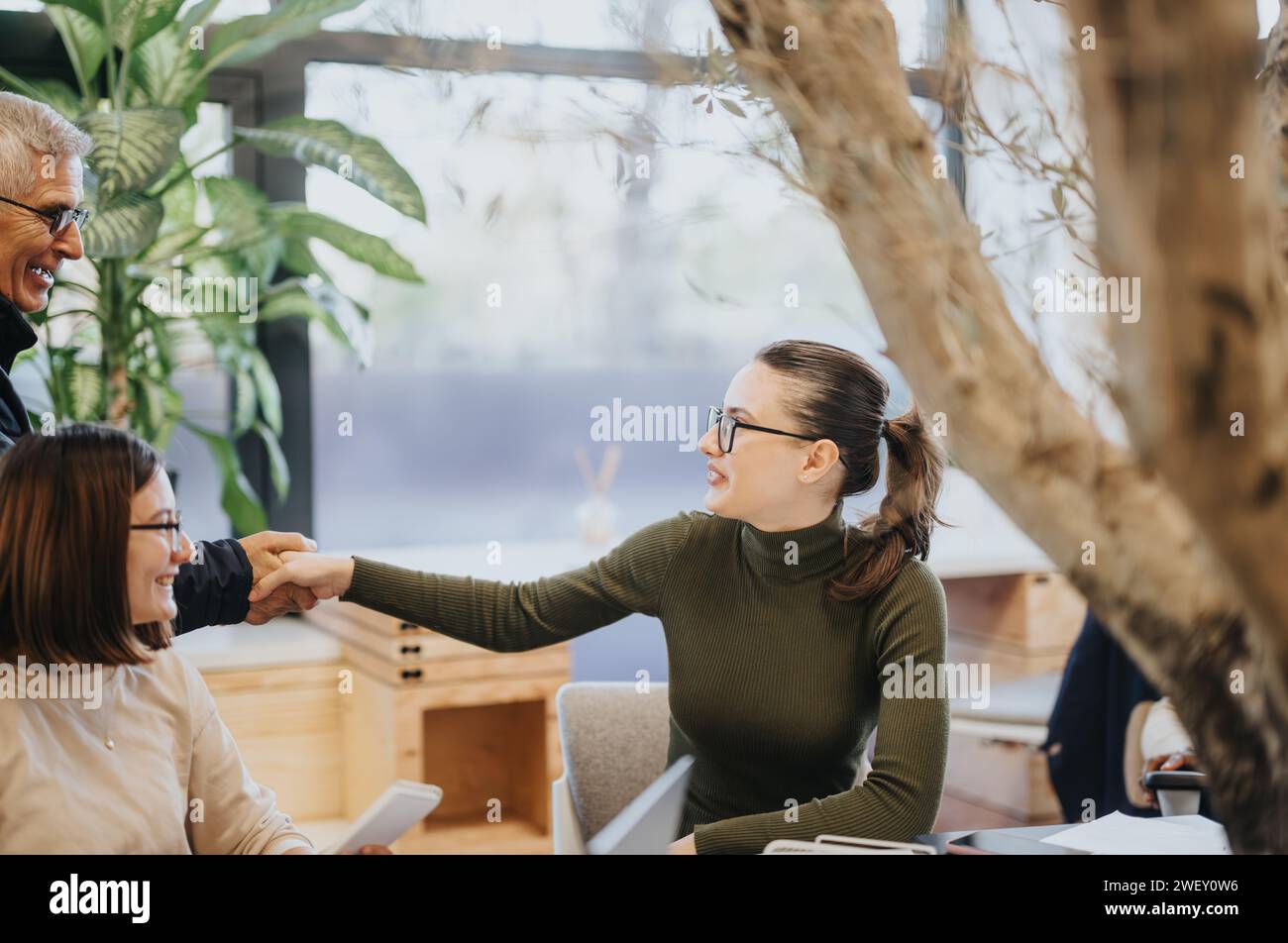 Group of corporate colleagues collaborating and analyzing statistics for business growth. Stock Photo