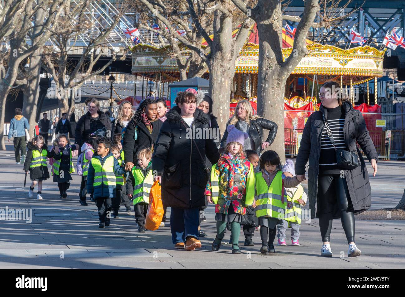 Nursery school children on a supervised walk or outing with teachers and teaching assistants, England, UK Stock Photo