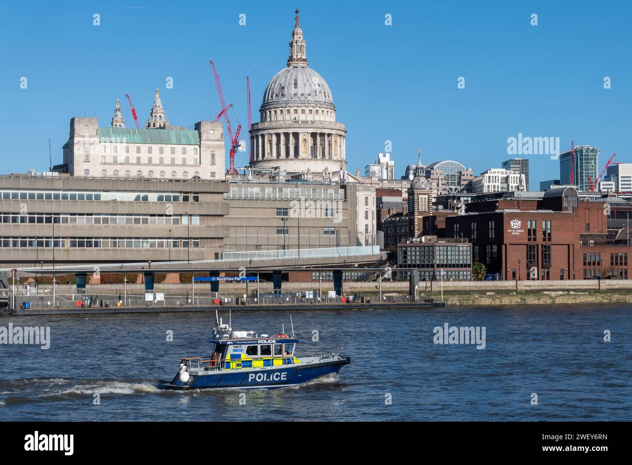 Police boat on the River Thames in central London, England, UK. Metropolitan police launch with St Paul's Cathedral in the background Stock Photo