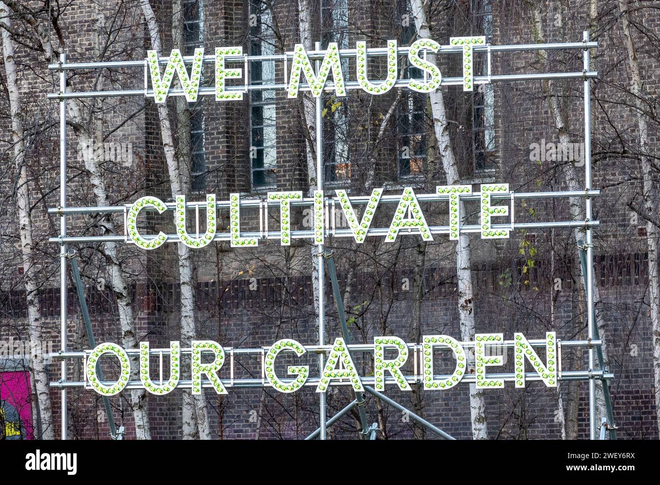 We Must Cultivate Our Garden text-based sculpture by artist Nathan Coley outside the Tate Modern art gallery, London, England, UK Stock Photo