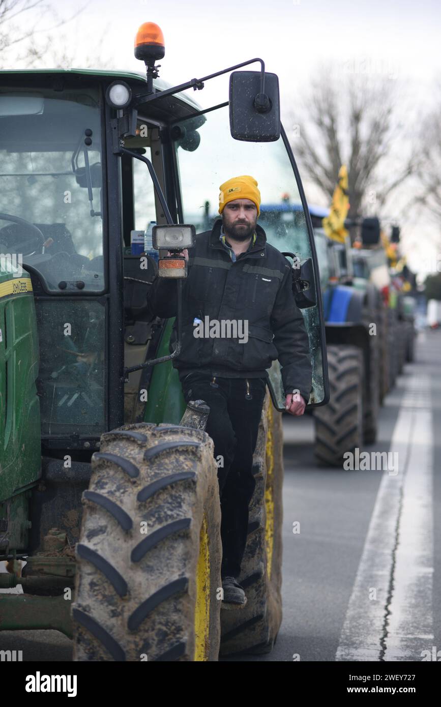 *** STRICTLY NO SALES TO FRENCH MEDIA OR PUBLISHERS - RIGHTS RESERVED ***January 27, 2024 - Mitry-Mory, France: Portrait of French cereal producer Adrien Quignot, a 37-yo member of the Coordination Rurale union, wearing  the union's distinctive yellow beanie. He drove his tractor as part of a protest towards Paris CDG airport, amid threats to block traffic around the French capital. Farmers angered over low remuneration, red tape, and unfair imports have vowed to continue protesting, maintaining traffic barricades on motorways, a day after the government's series of pro-agriculture measures. Stock Photo