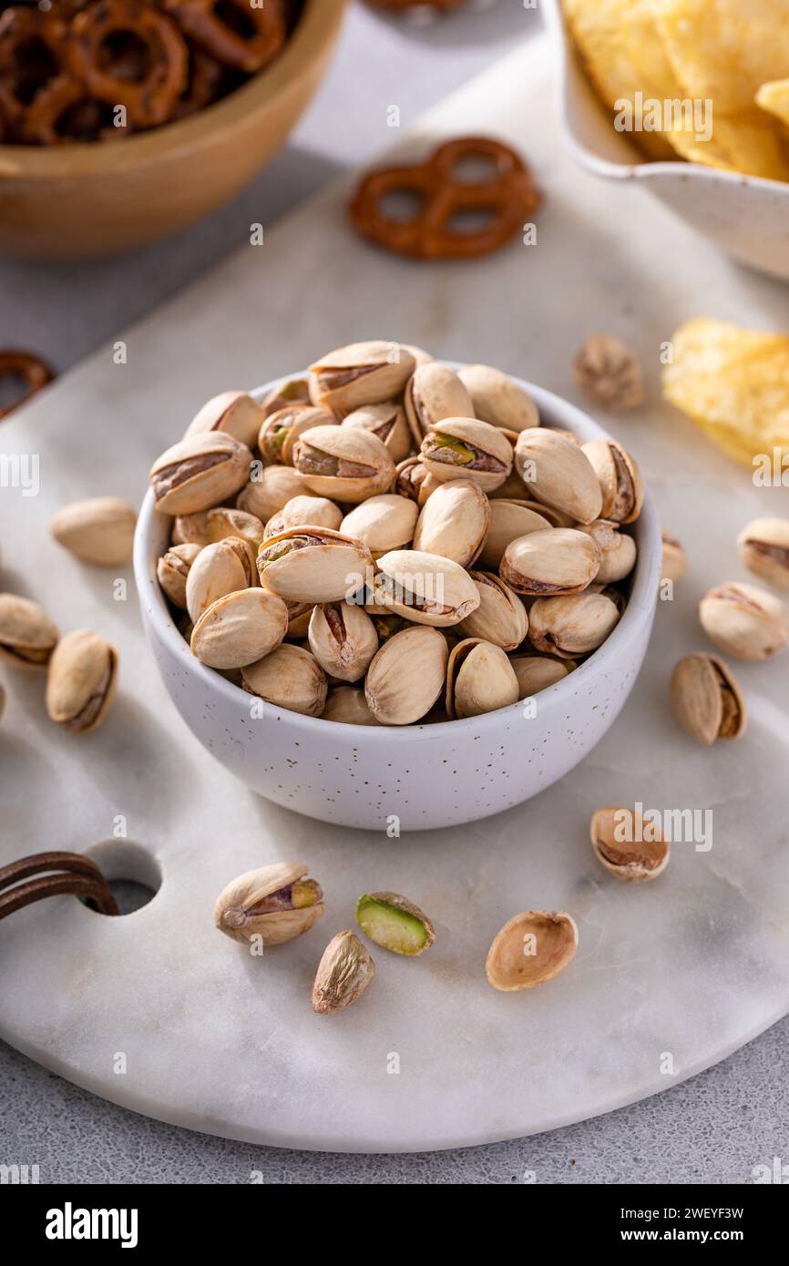 Salted pistachios with other salty snacks served with beer Stock Photo