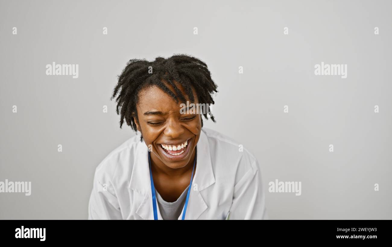 A joyful african american woman with dreadlocks, wearing a lab coat ...