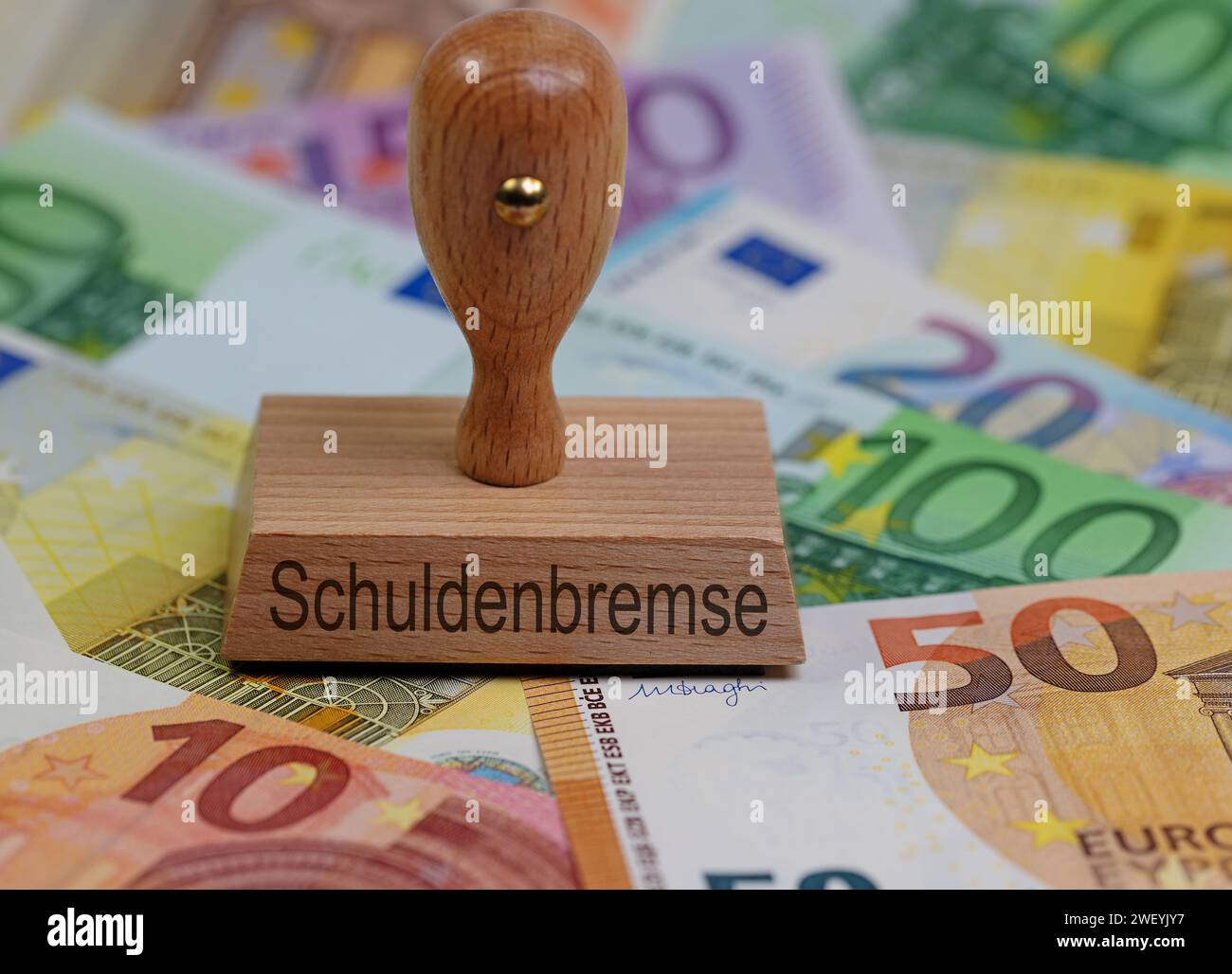 Wooden stamp with the imprint “Schuldenbremse”, translation “Debt Brake” Stock Photo