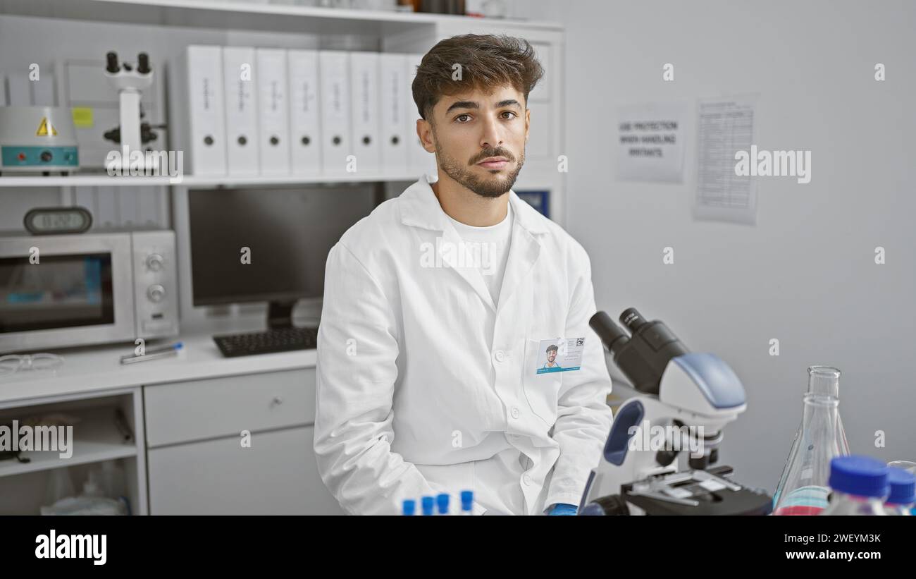 Young arab man scientist using microscope at laboratory Stock Photo