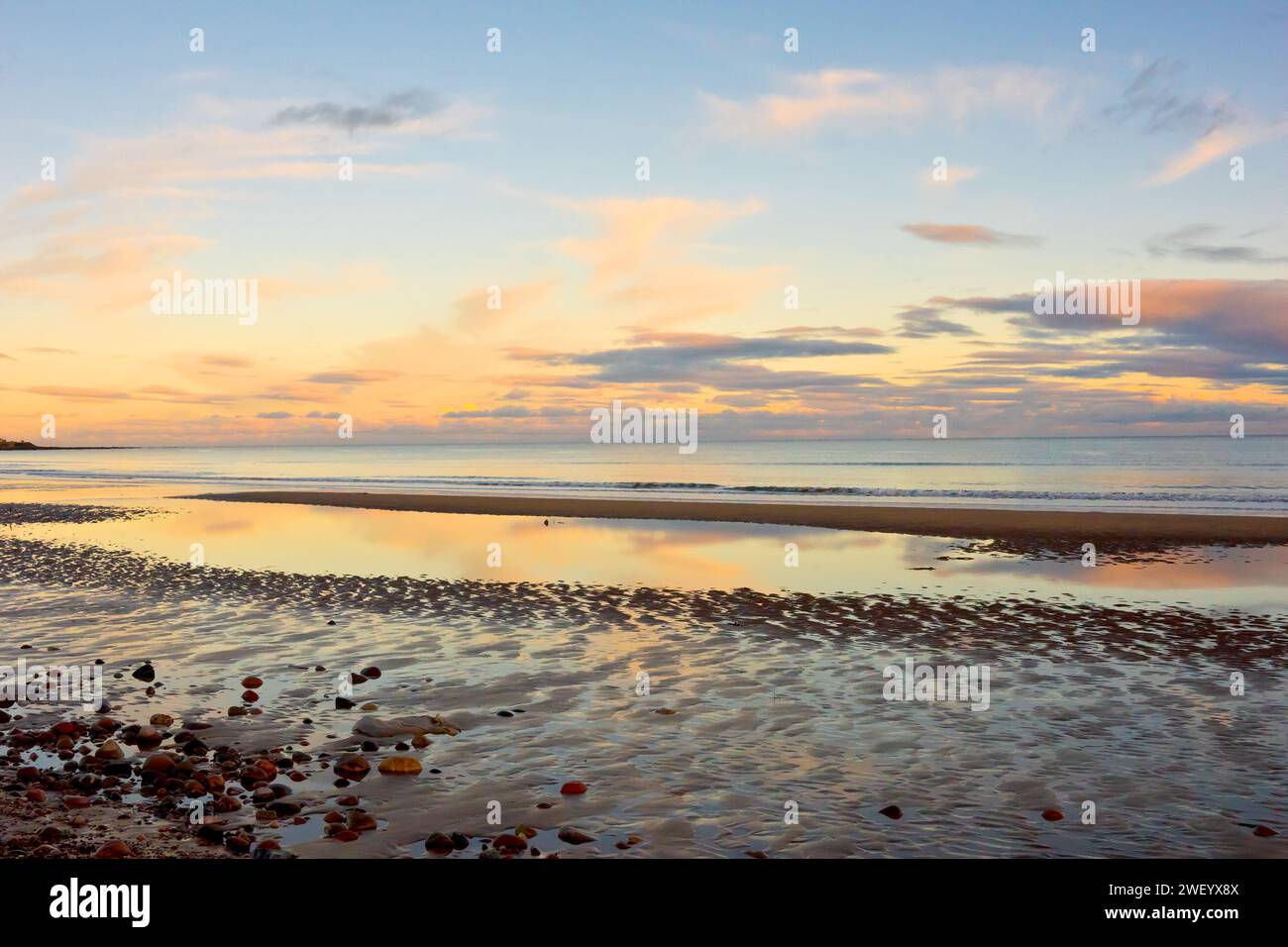 The beach at Arbroath on the east coast of Scotland, at twilight on a calm, clear autumn evening, the sky full of the subtle colours of the sunset. Stock Photo