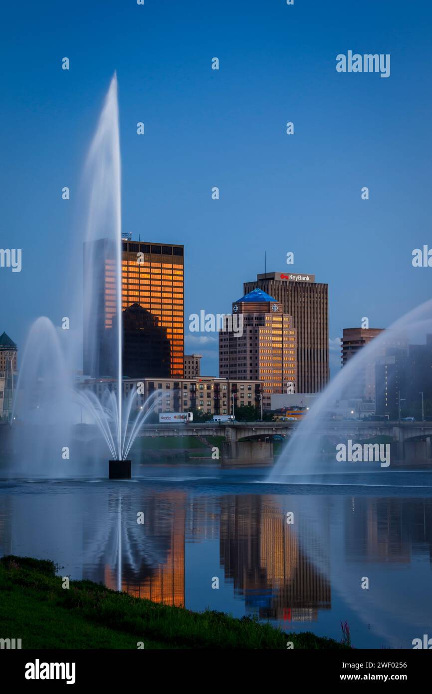 River water fountains and Dayton skyline as seen at evening from Deeds Point Metropark. Dayton, Ohio, USA. Stock Photo