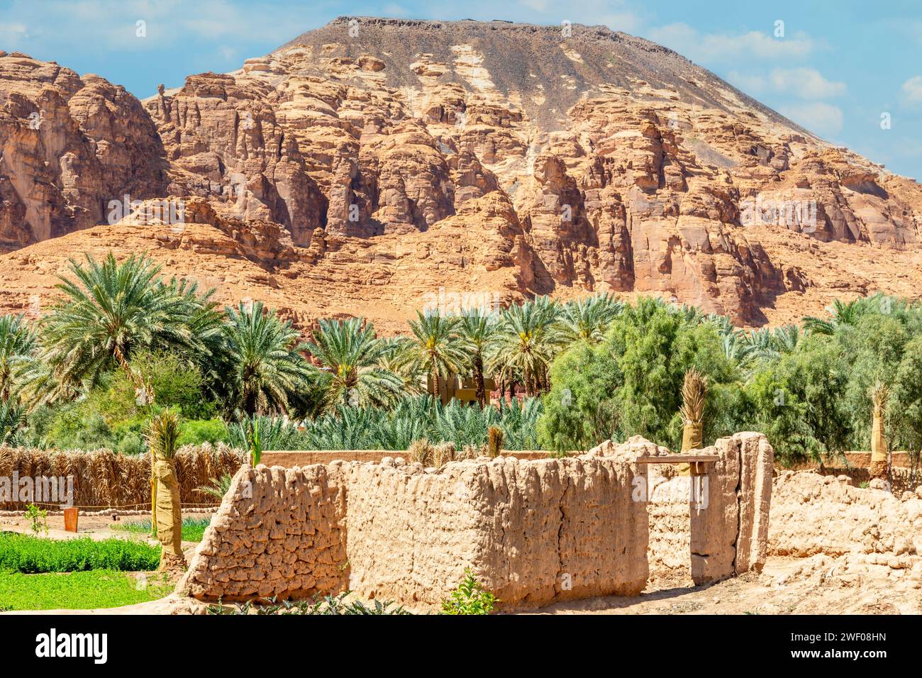 Al Ula ruined old town streets with palms and mountain in the background, Saudi Arabia Stock Photo