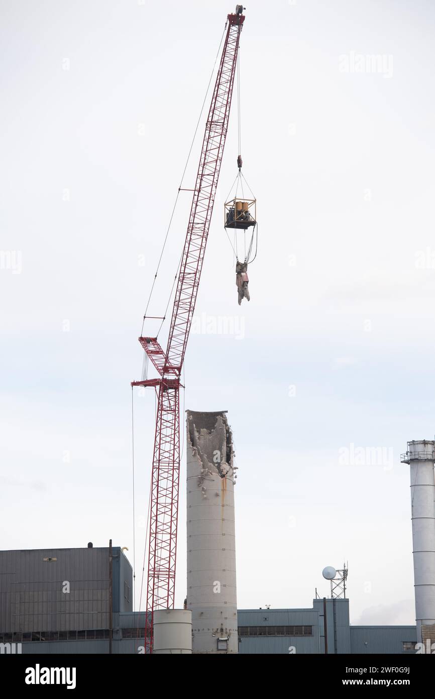 A crane takes down one of two smokestacks on the former coal burning power plant for Colorado Springs Utilities. Stock Photo