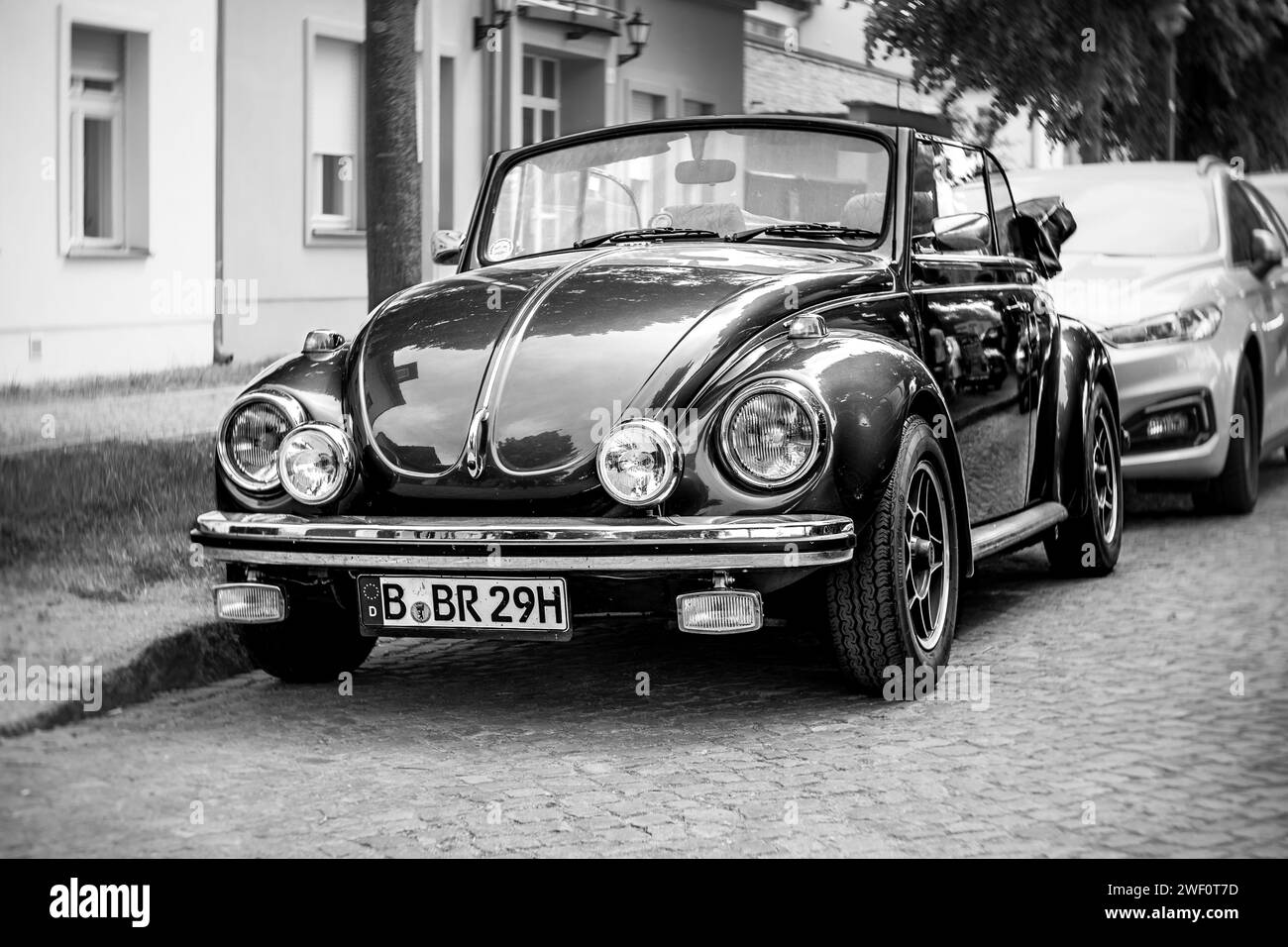 WERDER (HAVEL), GERMANY - MAY 20, 2023: The subcompact, economy car Volkswagen Beetle Convertible. Swirl bokeh, art lens. Black and white. Stock Photo
