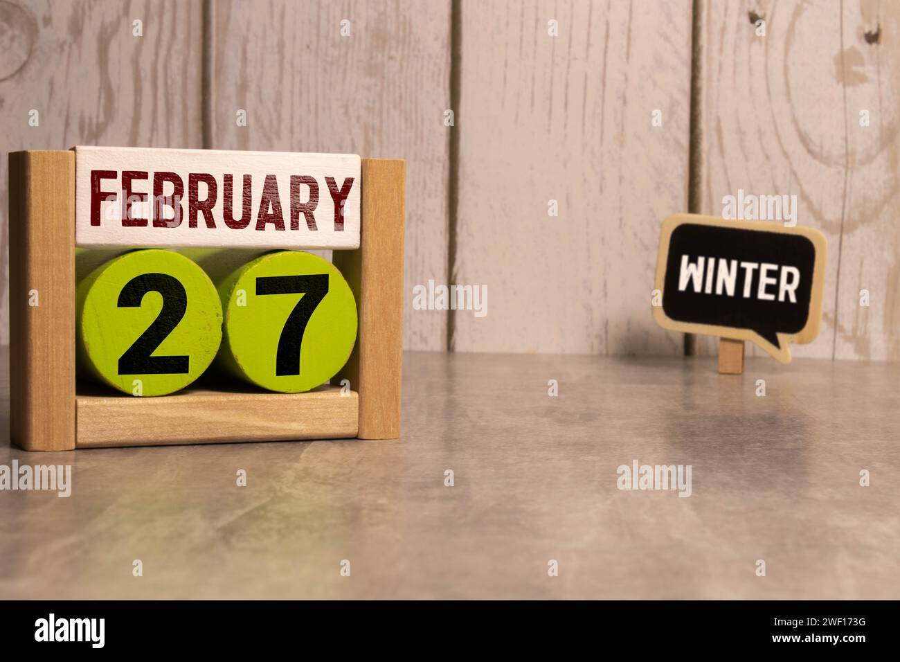 27 Februar on wooden grey cubes. Calendar cube date 27 February. Concept of date. Copy space for text or event. Educational cubes. Wood blocks in box Stock Photo