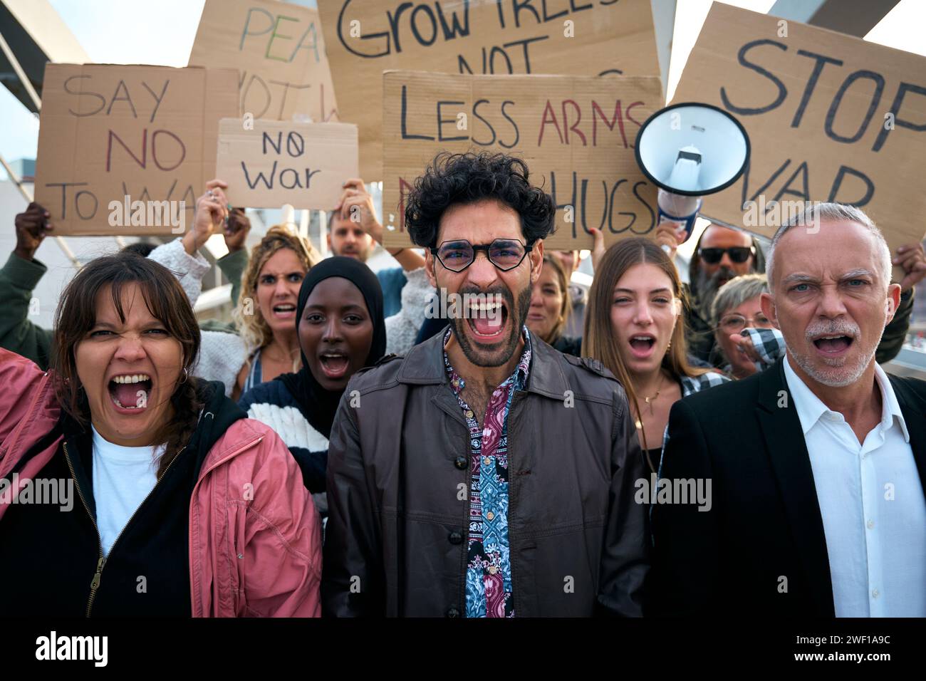 Multiracial diverse ages people protesting against war and violence in the world. Group of activists Stock Photo