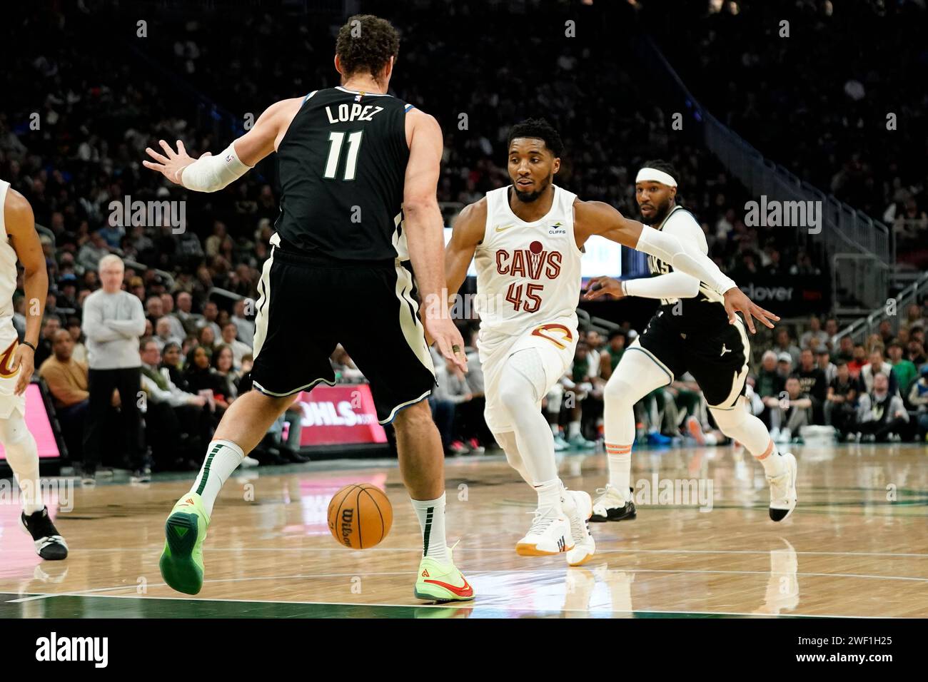 Cleveland Cavaliers' Donovan Mitchell (45) dribbles between Milwaukee ...