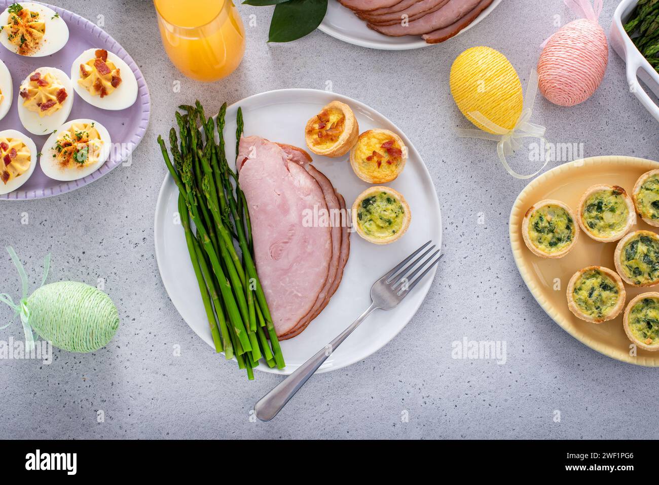 Easter brunch table with a potion of ham with asparagus on the plate ...