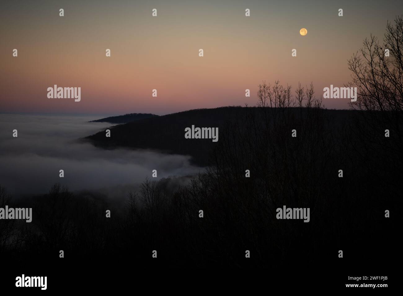 Colorful twilight hour with the moon in view as seen from the bluffs of