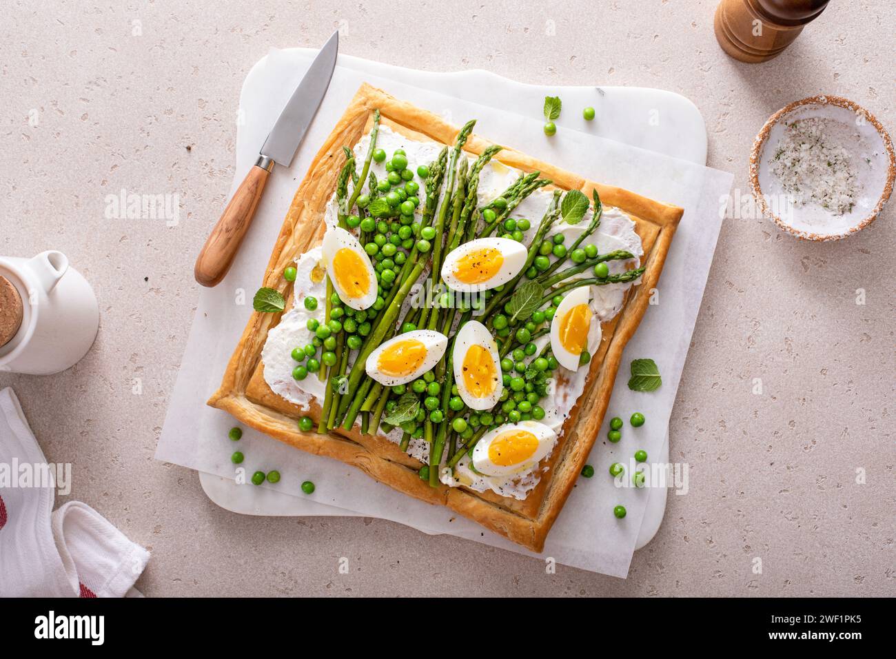 Asparagus and egg tart with peas, puff pastry and cream cheese, spring