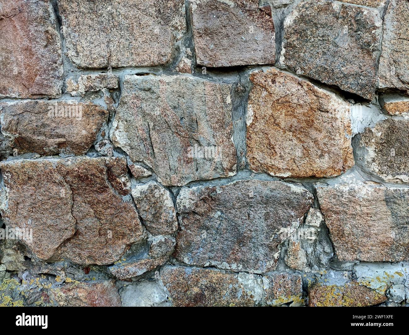 Background of large stones wall texture with different colors stones Stock Photo