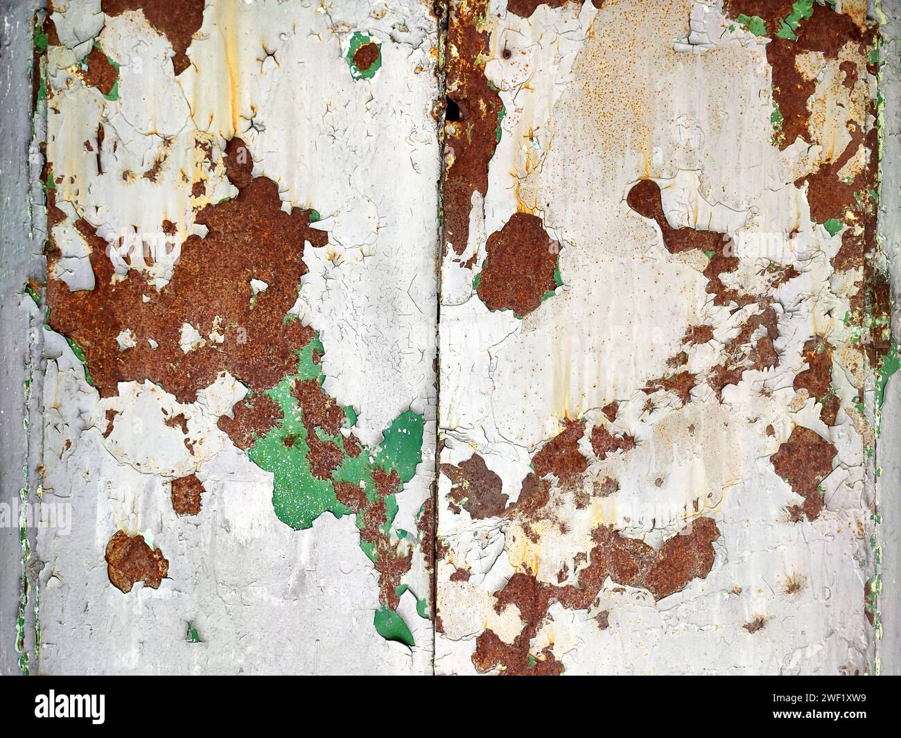 Rusted colorful painted metal wall. Rusty metal background with streaks of rust. Corroded metal background. Rust stains. The metal surface rusted spot Stock Photo