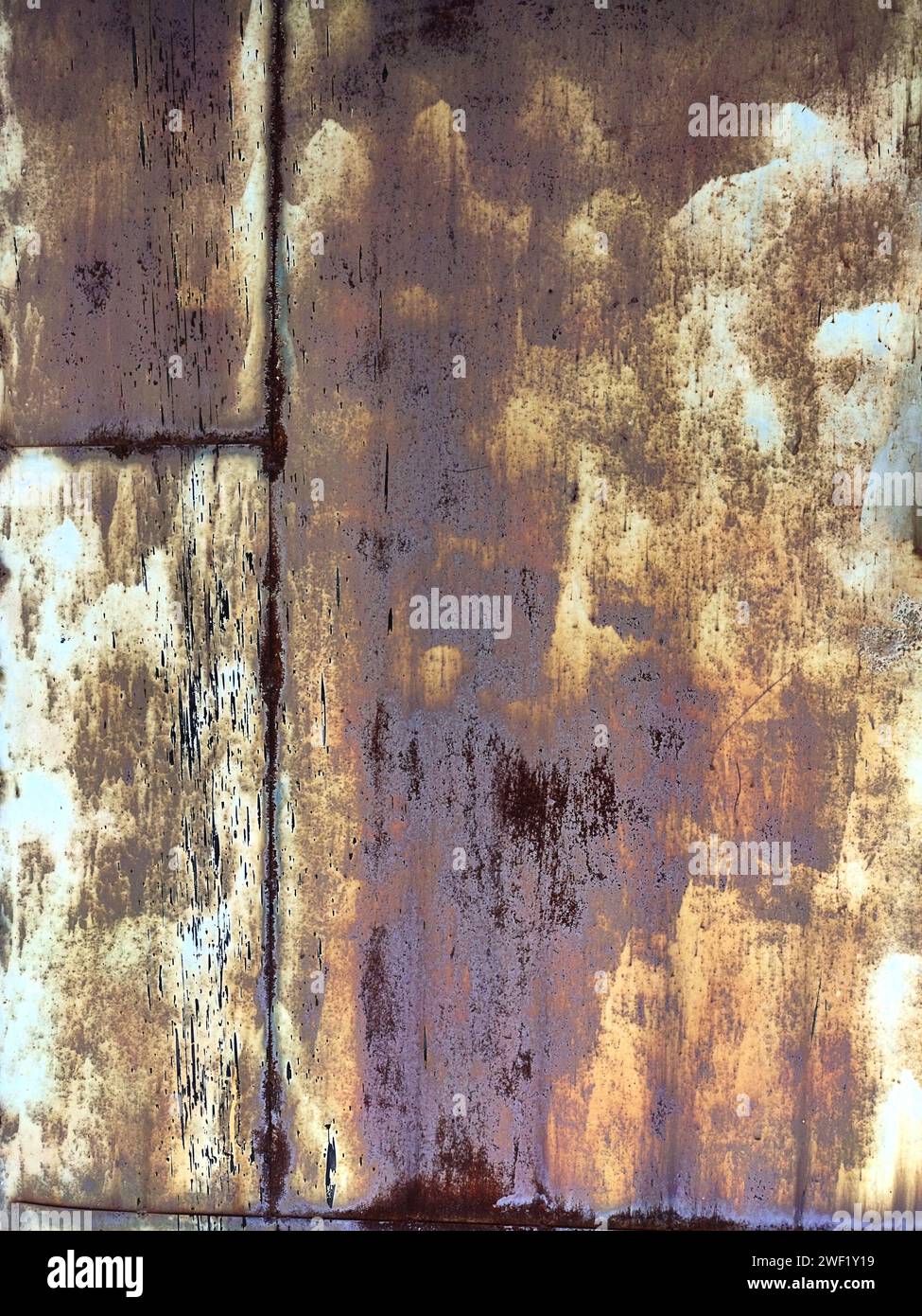 Rusted colorful painted metal wall. Rusty metal background with streaks of rust. Corroded metal background. Rust stains. The metal surface rusted spot Stock Photo