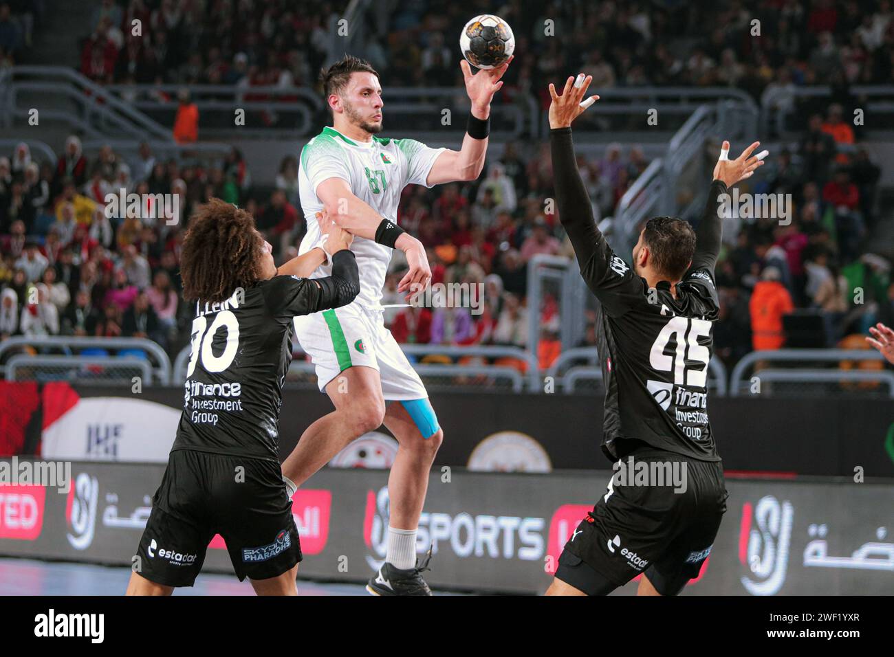 Cairo, Egypt. 27th Jan, 2024. Ayyoub Abdi (top) of Algeria shoots