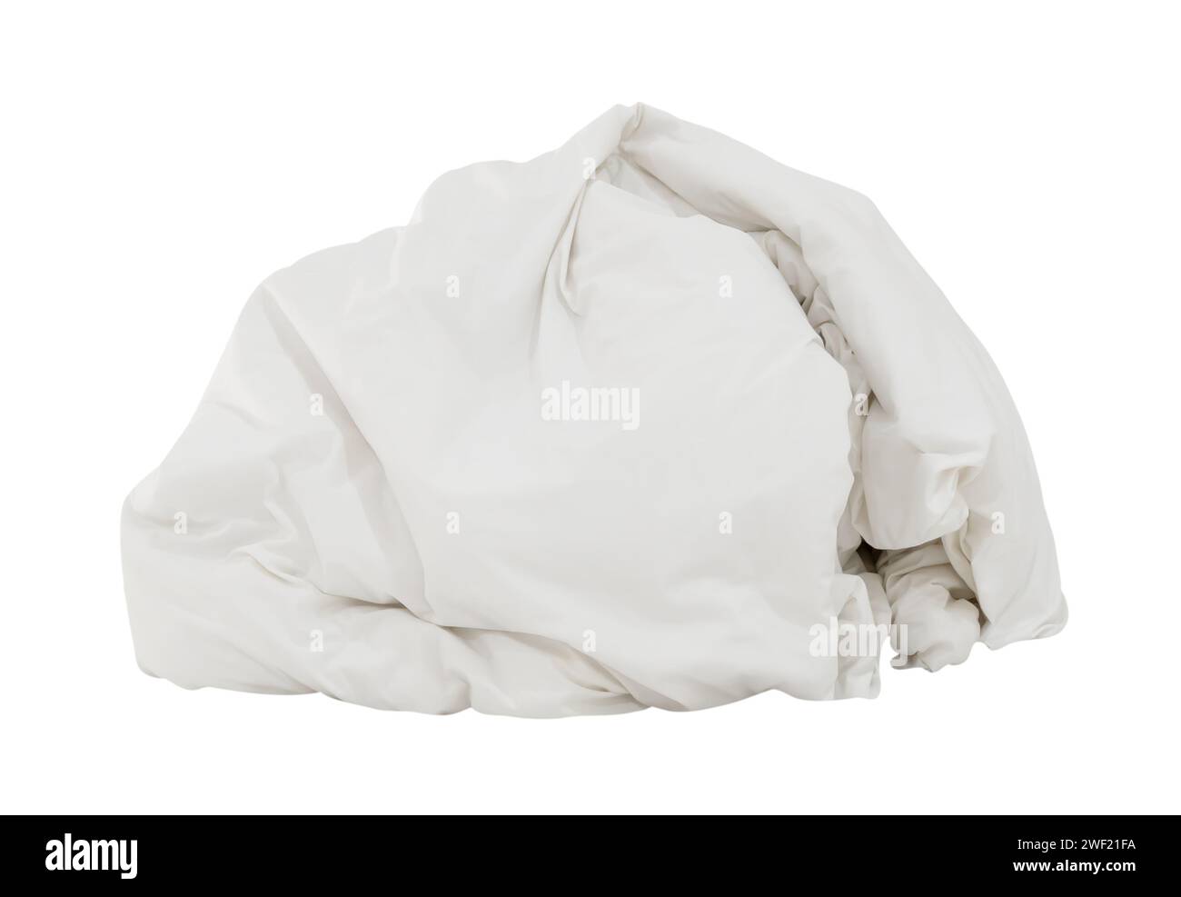 White crumpled blanket or bedclothes in hotel room leaved untidy and dirty after guest's use over night is isolated on white background with clipping Stock Photo