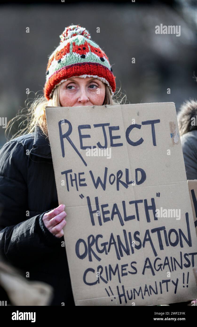 London, UK. 27th Jan, 2024. A protester holds a placard saying 'Reject The World Health Organisation (WHO) Crimes Against Humanity' during the demonstration. A group of protesters gathered to demonstrate against those in government and positions of power that they believe are allowing the sexualizing of children in the school curriculum, the COVID-19 vaccination of children, satanic ritual abuse, child trafficking, and the use of adrenochrome. They are demanding answers and a proper investigation that will hold all those in power accountable. Credit: SOPA Images Limited/Alamy Live News Stock Photo