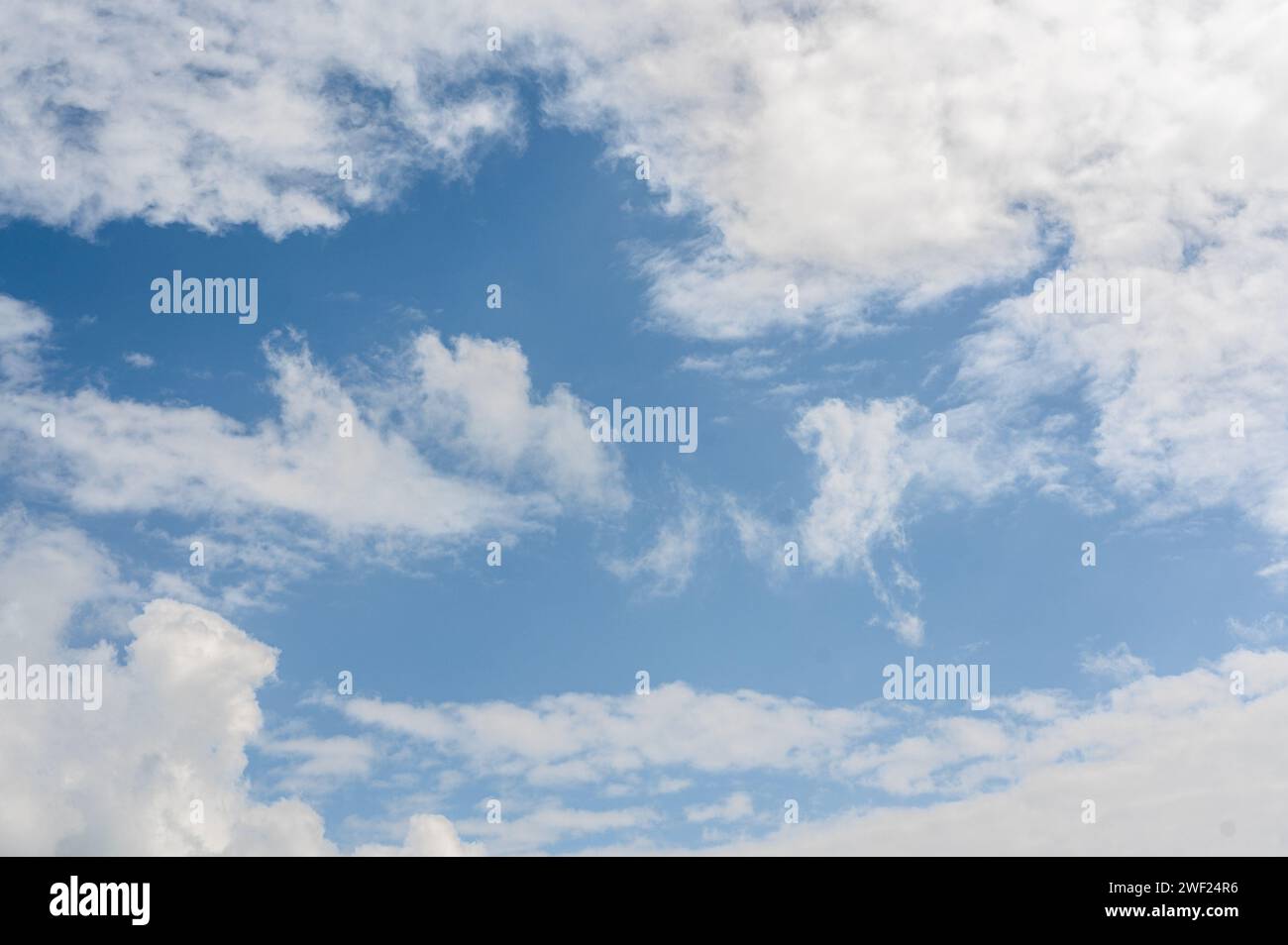 blue sky with fluffy white clouds background, creating serene and open ...