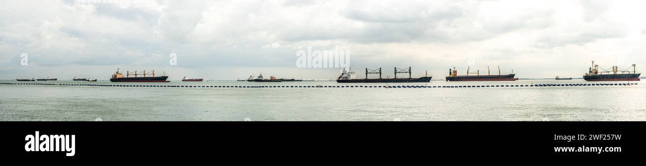 Singapore, Singapore, 24 January 2024: Panorama Commercial ships at sea, Singapore Strait. Cargo ships anchored in road, waiting to enter busiest port Stock Photo