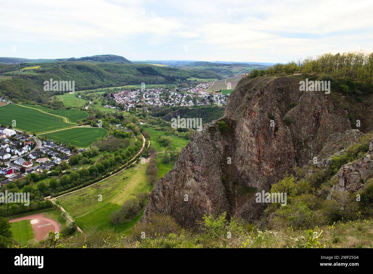Bad Munster, Germany - May 9, 2021: Rotenfels cliff overlooking German village, green fields and hills on a spring day. Stock Photo