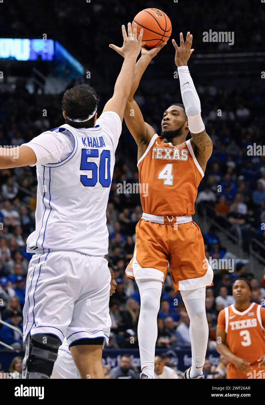 PROVO, UT - JANUARY 27: Texas Longhorns guard Tyrese Hunter (4) shoots over  Brigham Young Cougars center Aly Khalifa (50) during a college basketball  game between the Texas Longhorns and the BYU