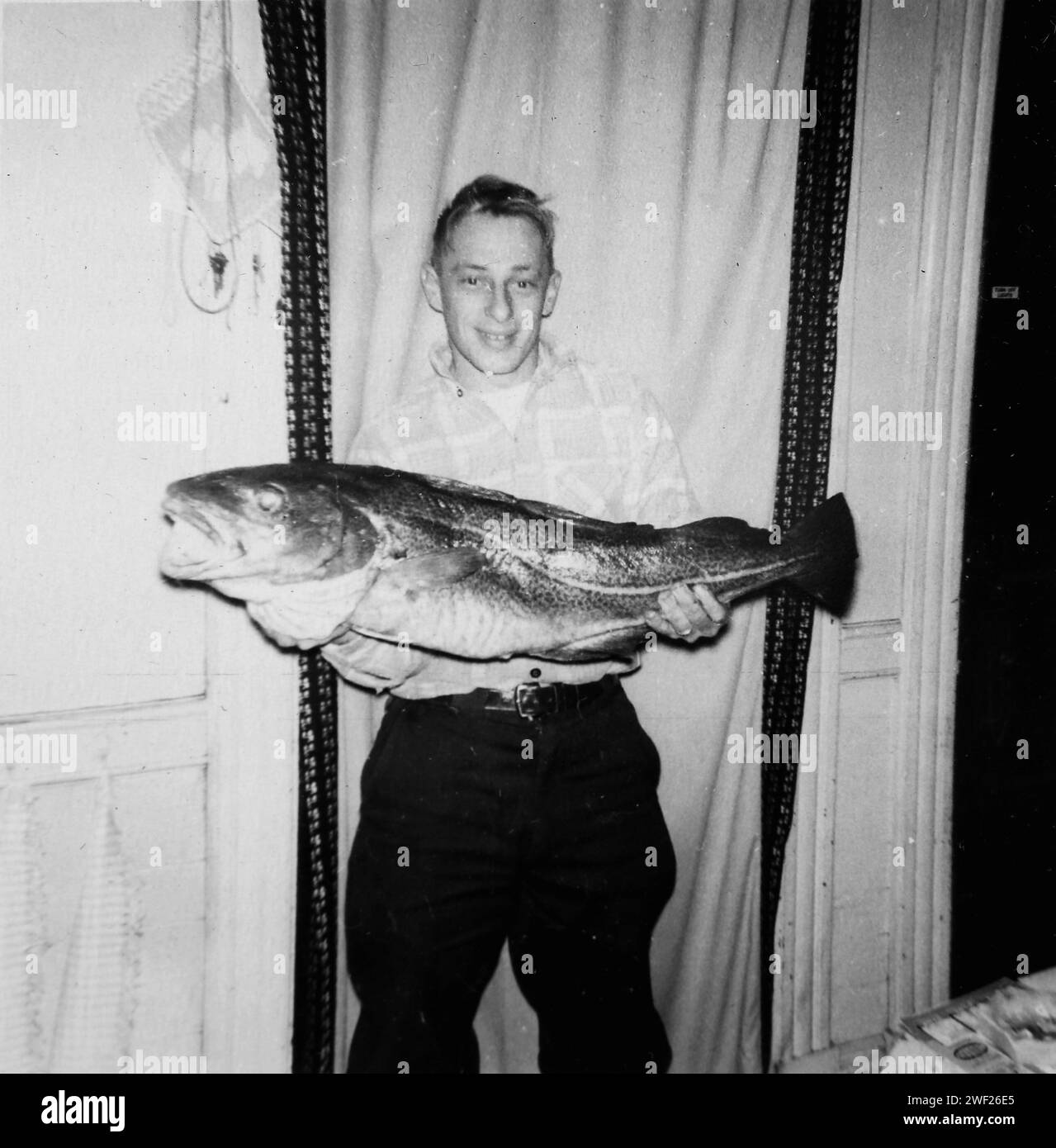 A man poses with his very large fish, ca. 1958 Stock Photo