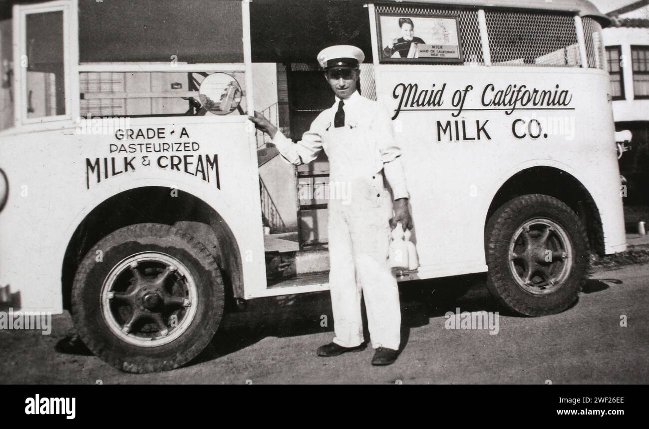 A dairy delivery man poses with his step truck on his route in California, ca. 1945. Stock Photo