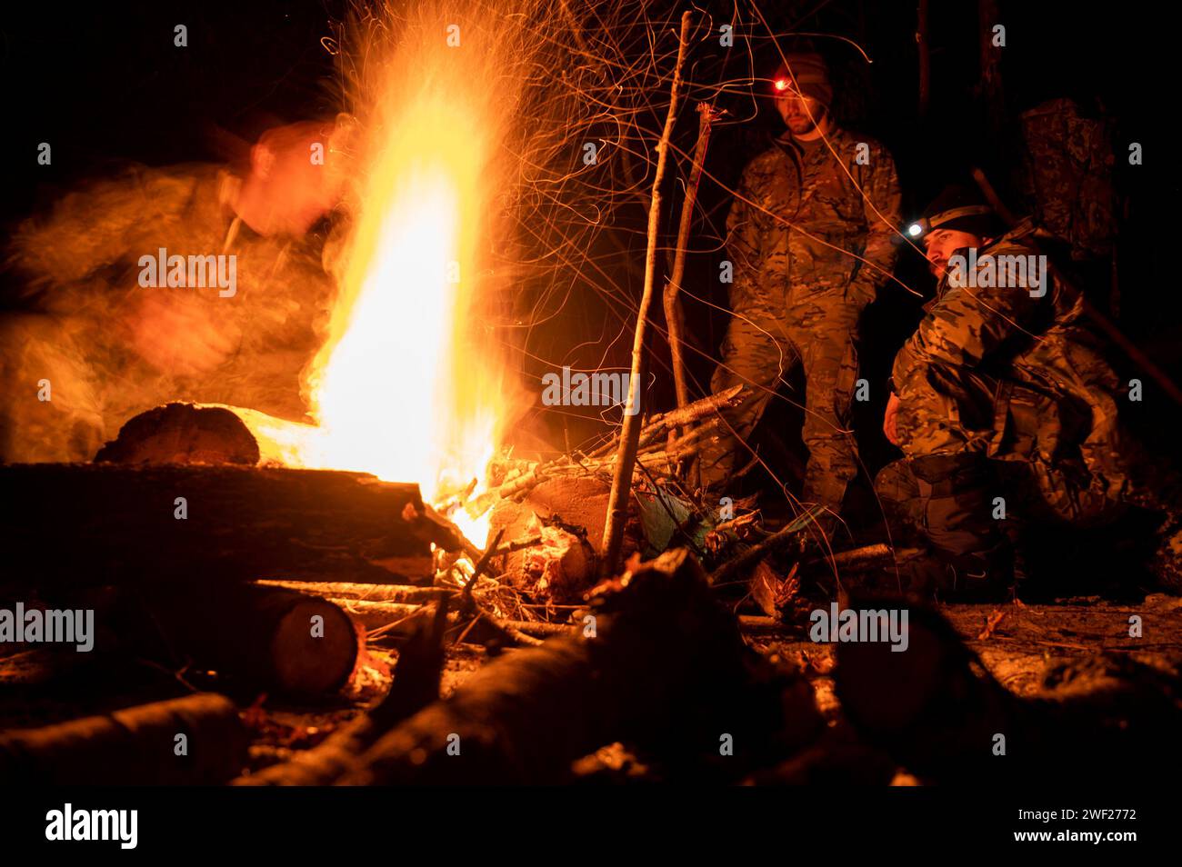 Little Falls, Minnesota, USA. 24th Jan, 2024. U.S. Navy Explosive Ordnance Disposal (EOD) Technicians assigned to Explosive Ordnance Disposal Group (EODGRU) 2 tend a campfire during arctic survivability training as part of Snow Crab Exercise 24-1. SNOWCRABEX is an annual exercise designed to test and evaluate U.S. Navy EOD and Navy Diver's capabilities and equipment in a simulated arctic environment and improve combat effectiveness. Navy EOD and Navy Divers are part of the Navy Expeditionary Combat Force (NECF), enabling the U.S. Navy Fleet by clearing and protecting the battlespace. (Cr Stock Photo