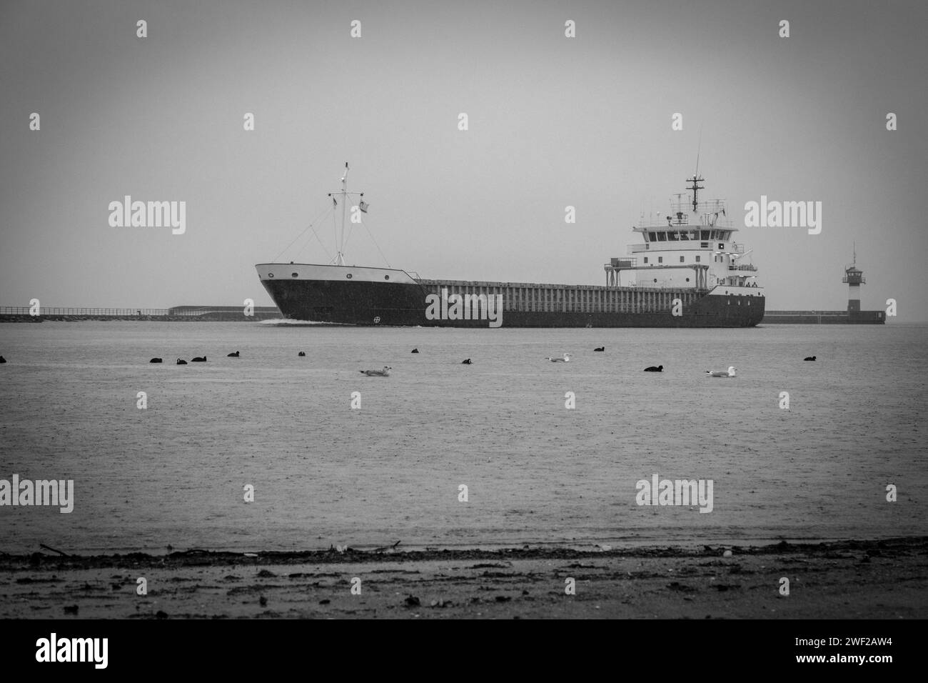 A tanker enters the port of Lübeck-Travemuende in rainy weather Stock Photo