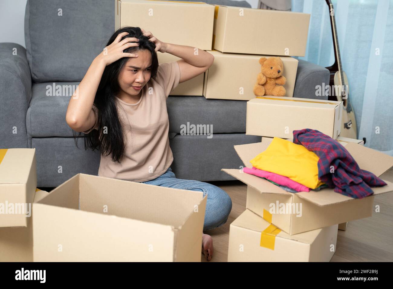 Young woman looking tired from so much effort during the relocation. Stock Photo